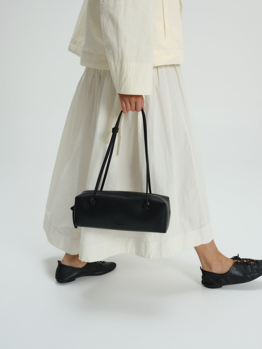 Sac à bandoulière compact en cuir végétalien de qualité supérieure, longues anses nouées, fermeture zippée
